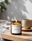 Candle labeled 'Blueberry Hibiscus Tea' with a cup and saucer in the background on a wooden surface.