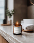 Lavender and Eucalyptus soy candle styled in bright calming bathroom setting
