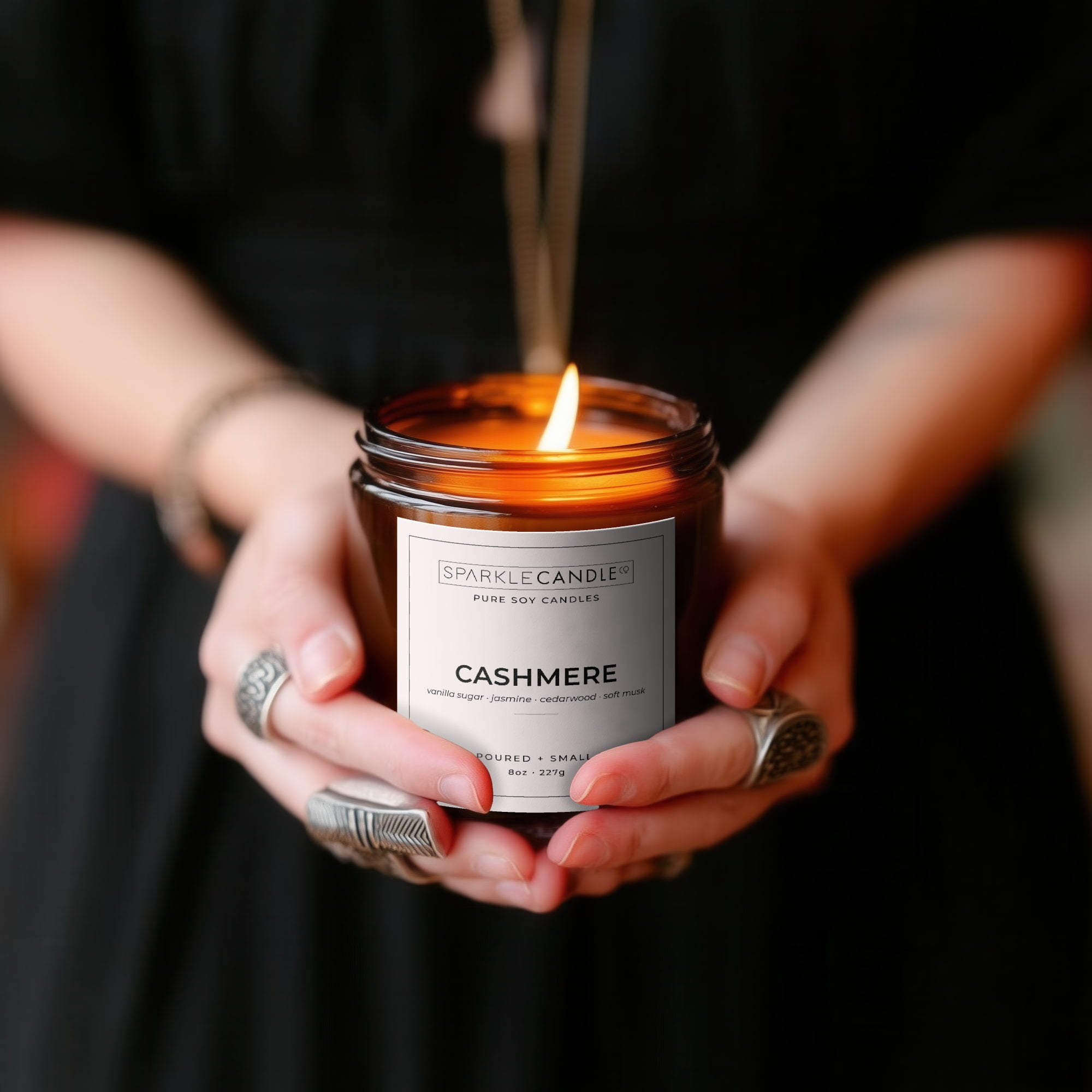 Person holding a Sparkle Candle Cashmere candle