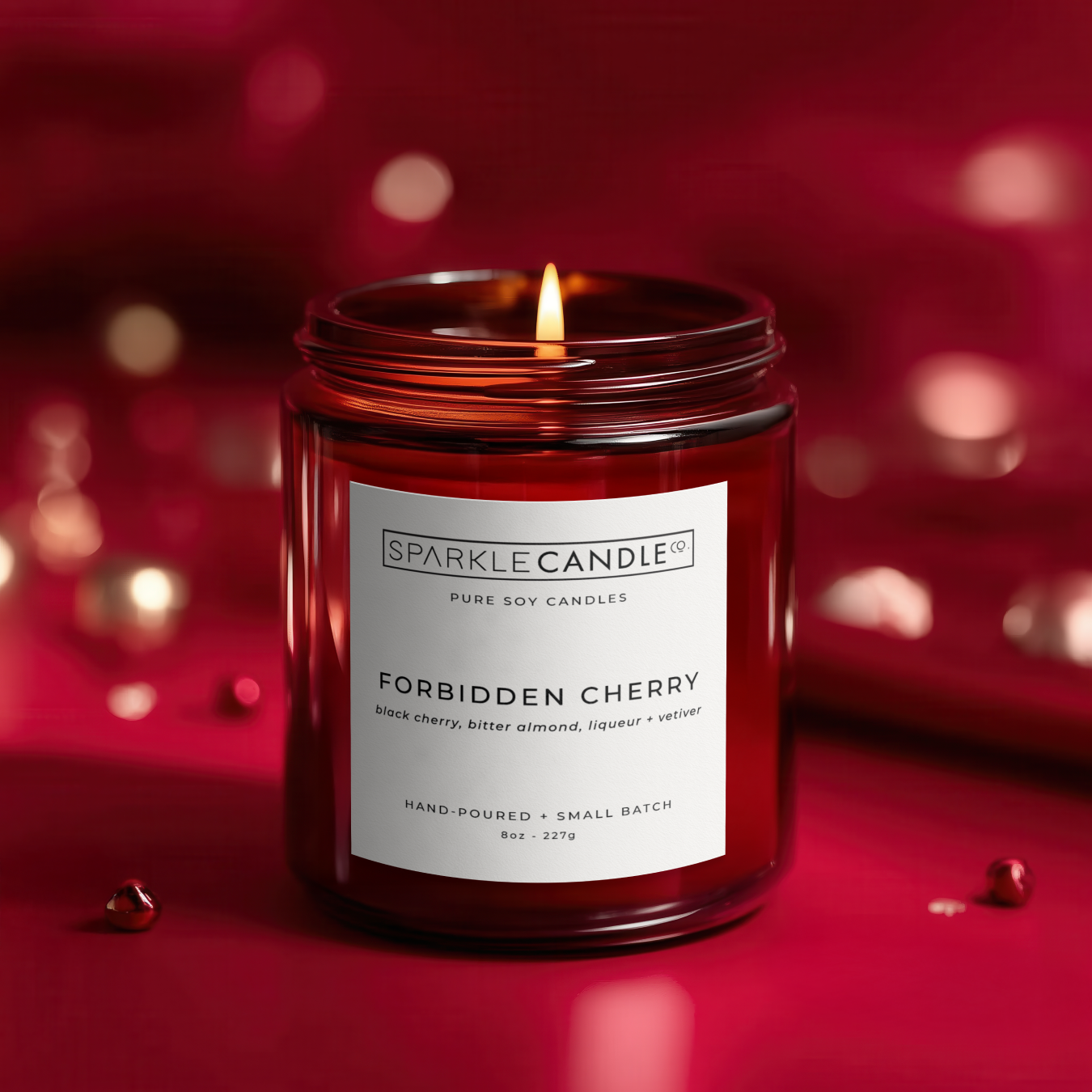 Sparkle Candle Co. Forbidden Cherry candle in a red jar with a blurred red background