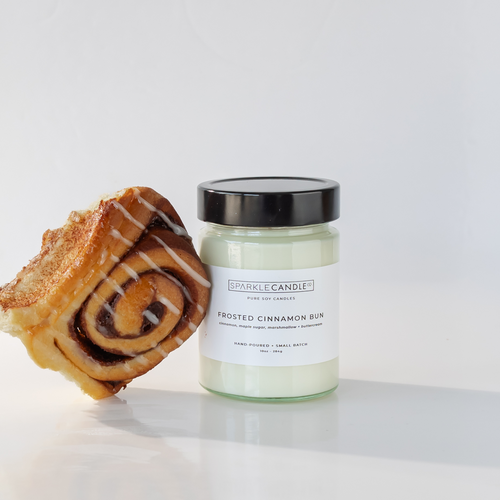 Frosted Cinnamon Bun hand-poured soy candle in glass jar, warm bakery-inspired scent