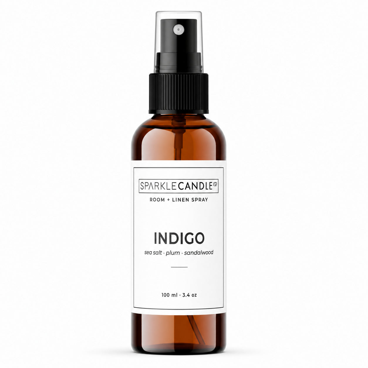 Brown spray bottle with 'Sparkle Candle'  Indigo room and linen label on a white background