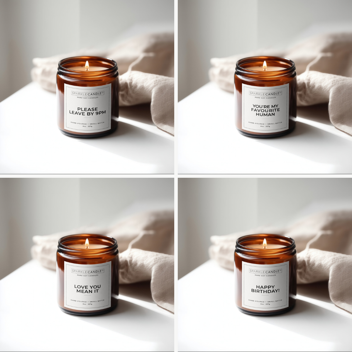 Four different candles with labels on a white surface with beige fabric.